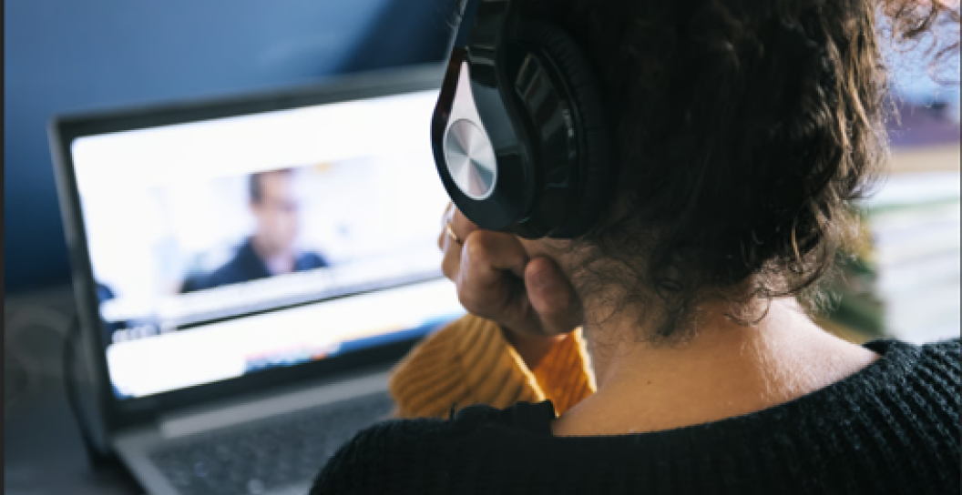 Woman watches online webinar