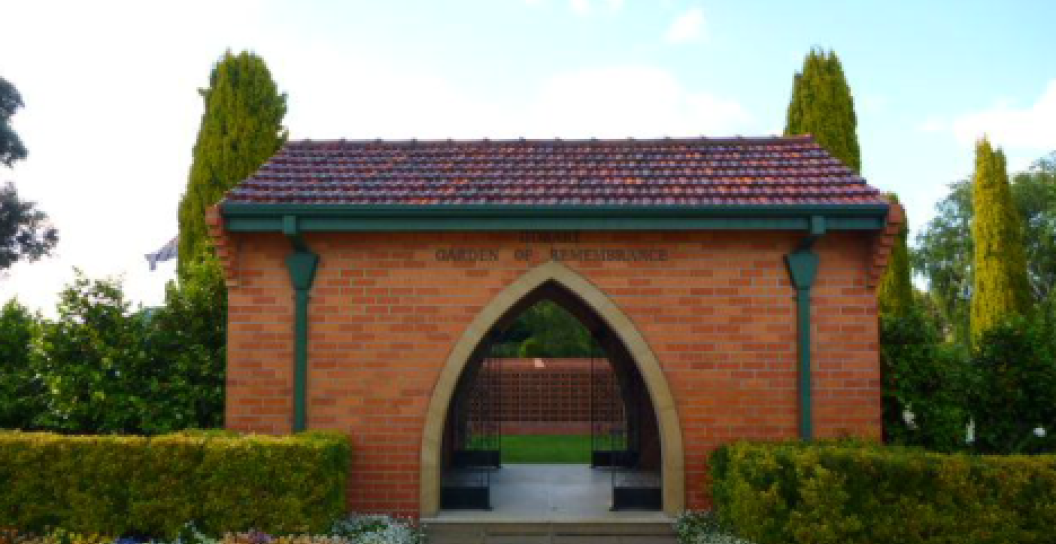 Picture of the Hobart Garden of Remembrance. Red brick building surrounded in trees and garden