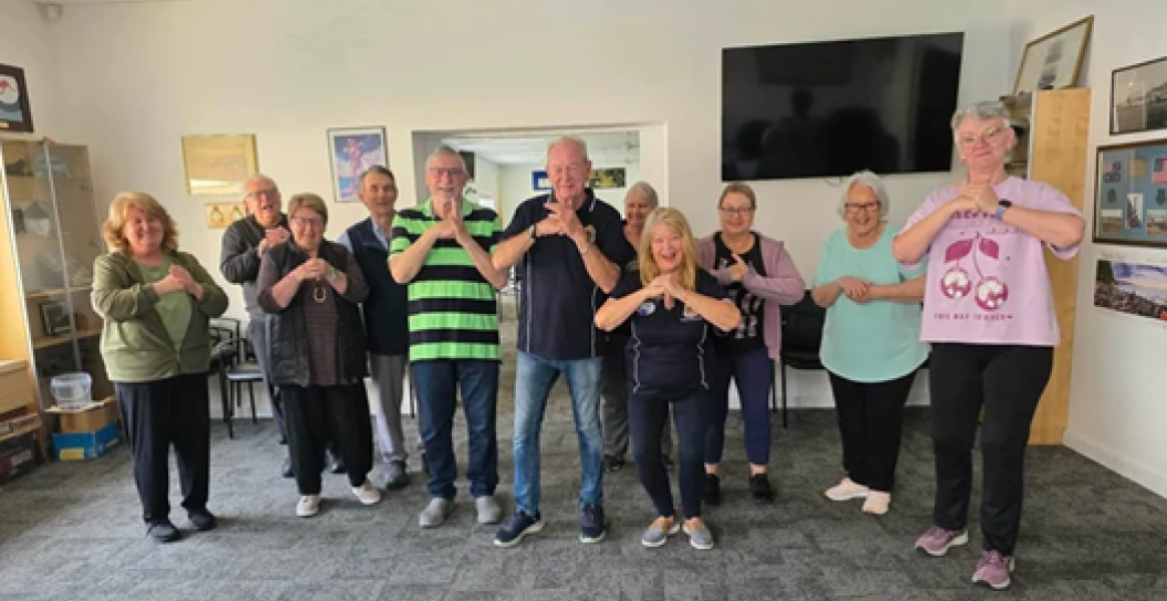 A group of elderly veteran community members exercising