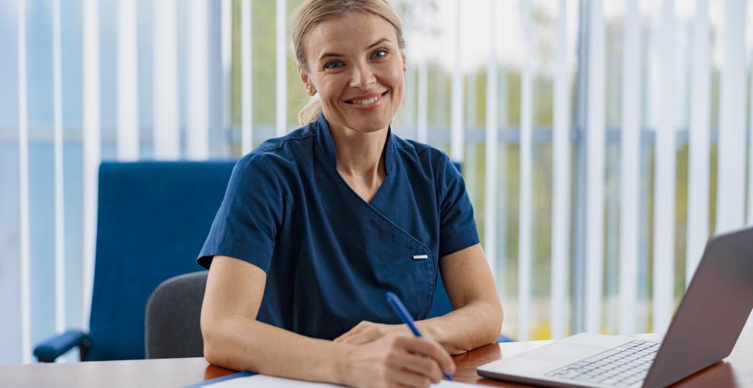 Smiling woman writes on notepad