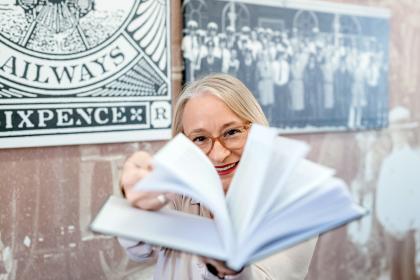Female veteran  holds book