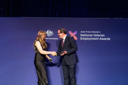 Woman winning award on stage