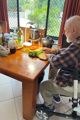 Veteran chopping vegetables at his table